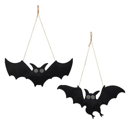 Two black hanging bat decorations with twine hangers and round eyes on a white background.
