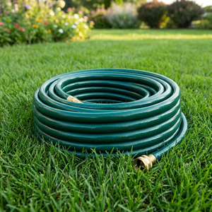 Garden Hose on Lawn | Suburban Lawn & Garden Green garden hose coiled on healthy grass in a sunny yard
